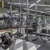 Solstice Signature Apartments fitness center with multiple weight lifting racks and cardio equipment