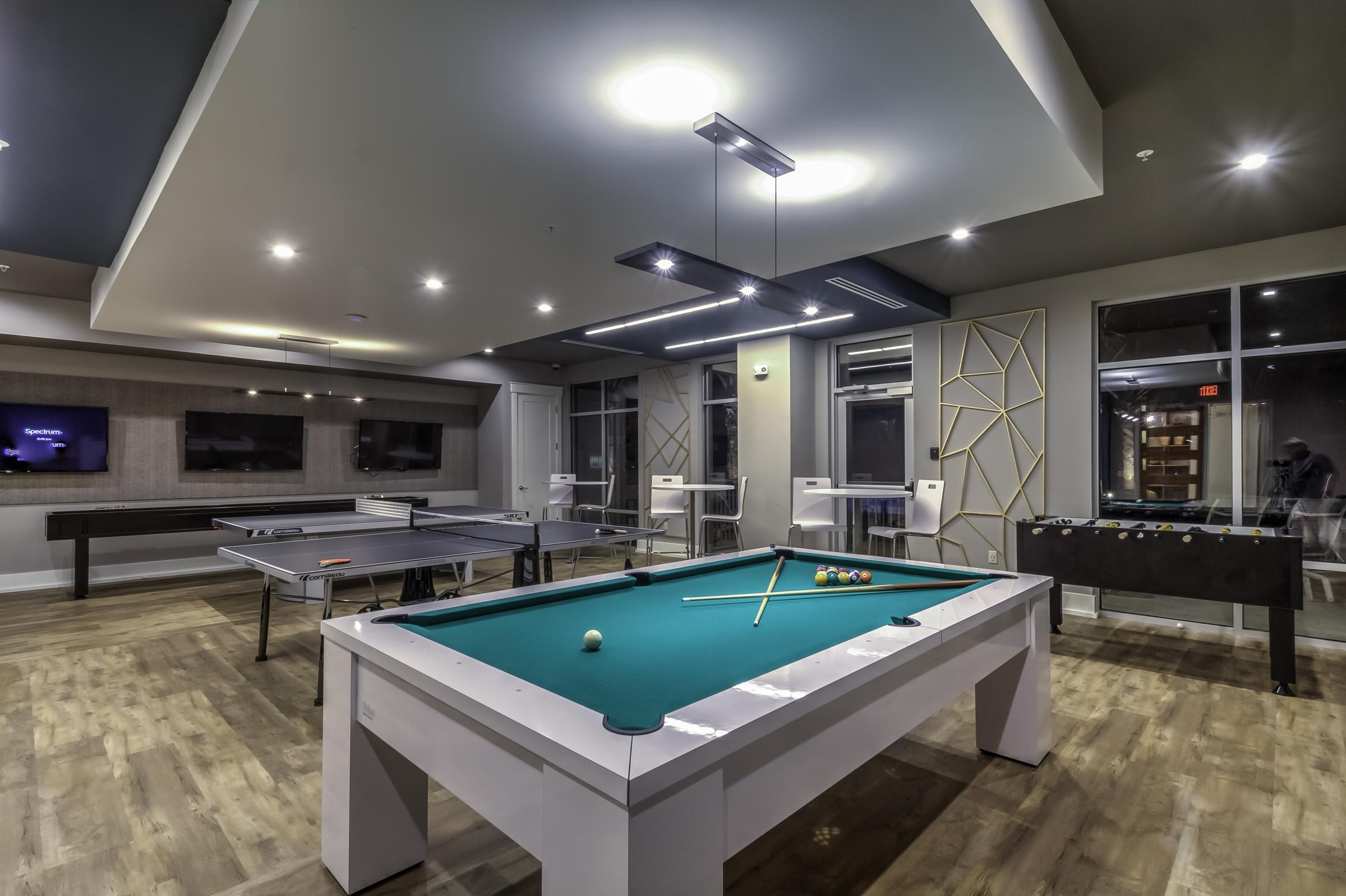 Solstice Apartments resident game room with billiards, ping pong, and foosball tables.