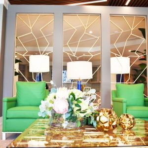 Solstice Apartments resident clubhouse lounge area with funky lime green arm chairs in front of a large coffee table.