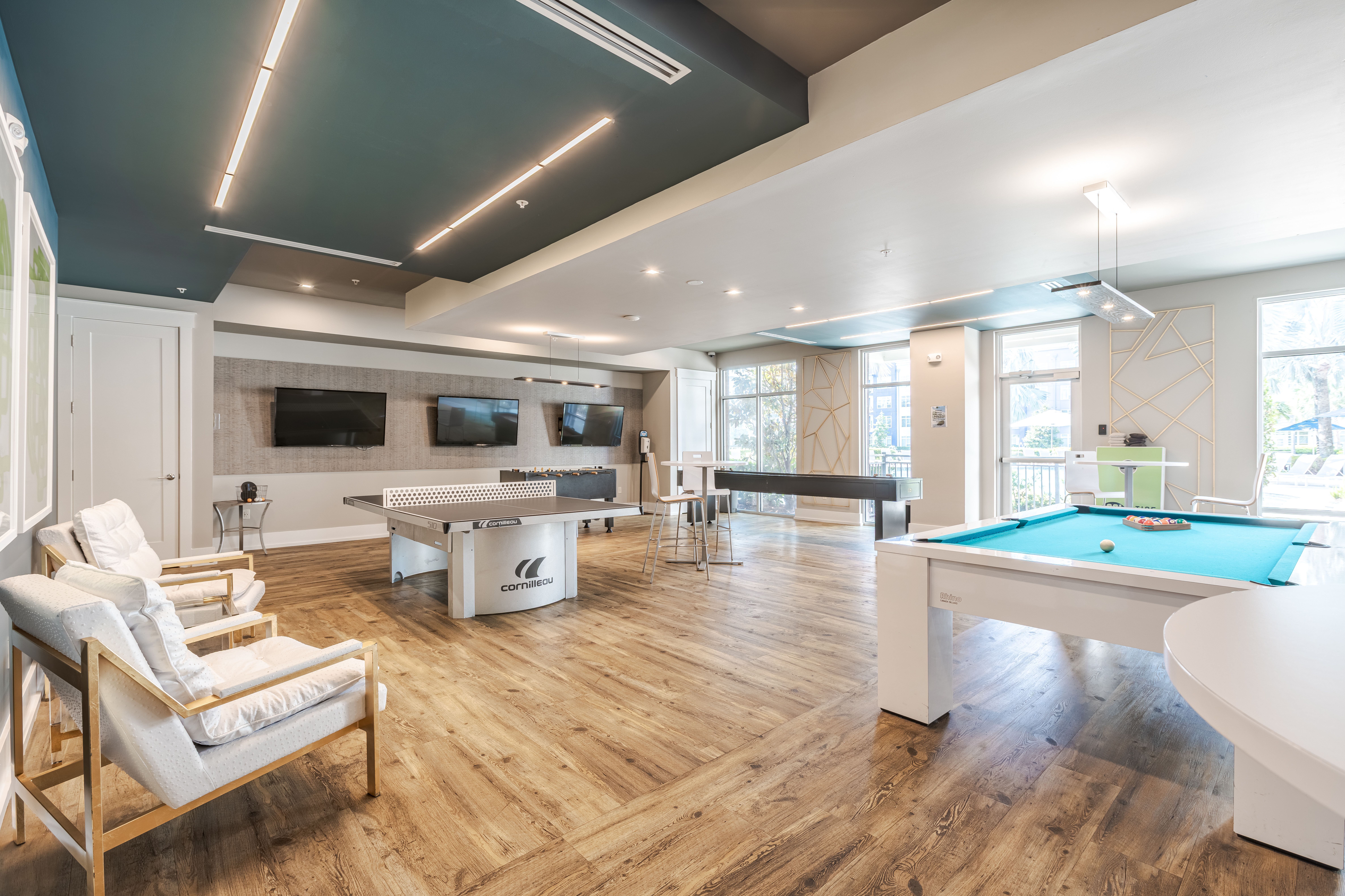Solstice Apartments resident game room with billiards, ping pong, and foosball tables.