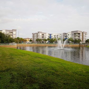 Solstice Apartments exterior building with waterway and fountain