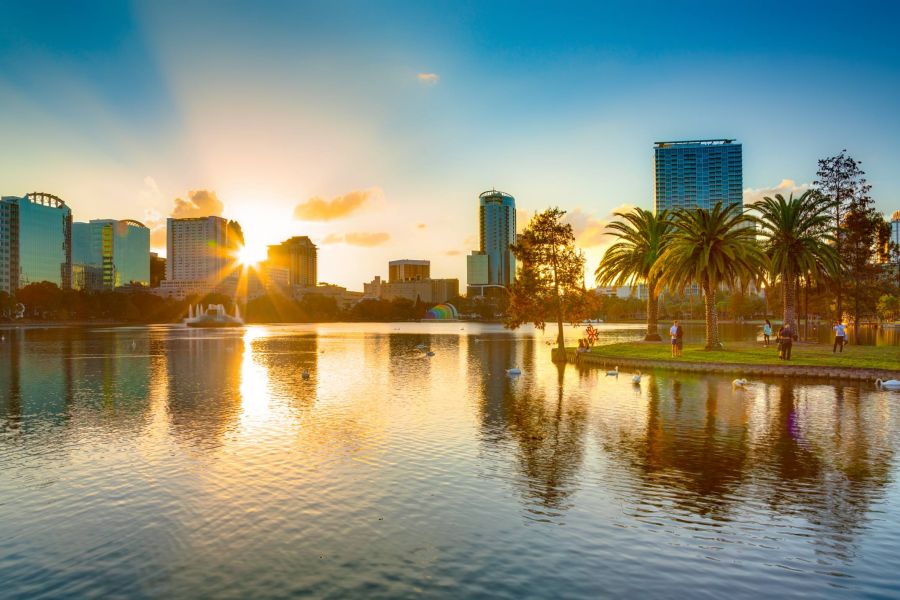Beautiful sunset view of water and park with Orlando Florida city skyline in background
