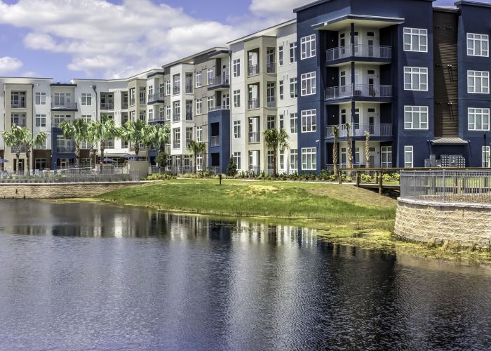 Solstice Apartments exterior view situated alongside a beautiful expansive lake.