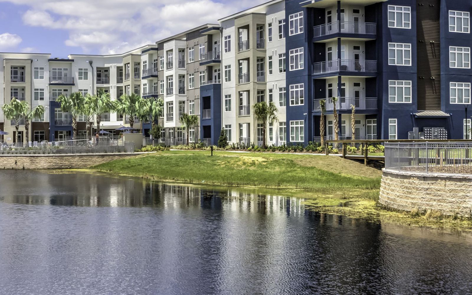 Solstice Apartments exterior view situated alongside a beautiful expansive lake.